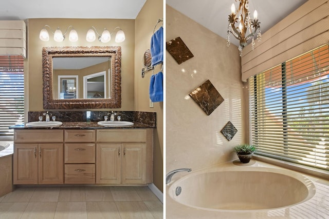 full bath with a bath, a notable chandelier, double vanity, and a sink