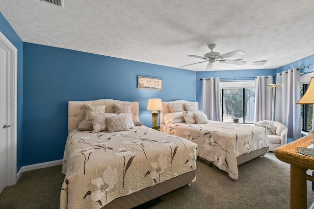 carpeted bedroom featuring baseboards, a textured ceiling, and a ceiling fan