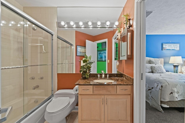 ensuite bathroom with vanity, toilet, combined bath / shower with glass door, and connected bathroom