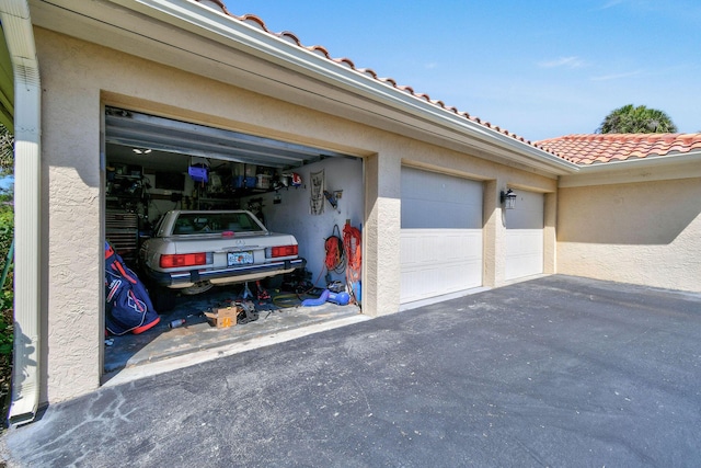 garage with aphalt driveway