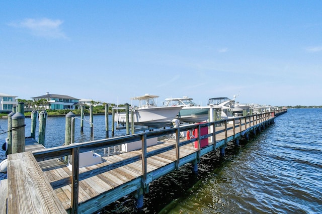 dock area with a water view and boat lift