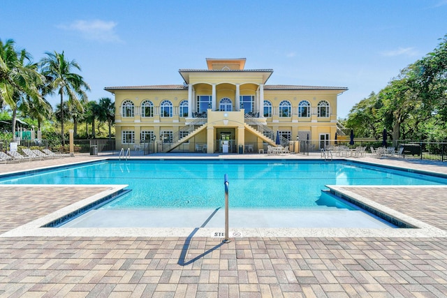 pool featuring a patio area and fence