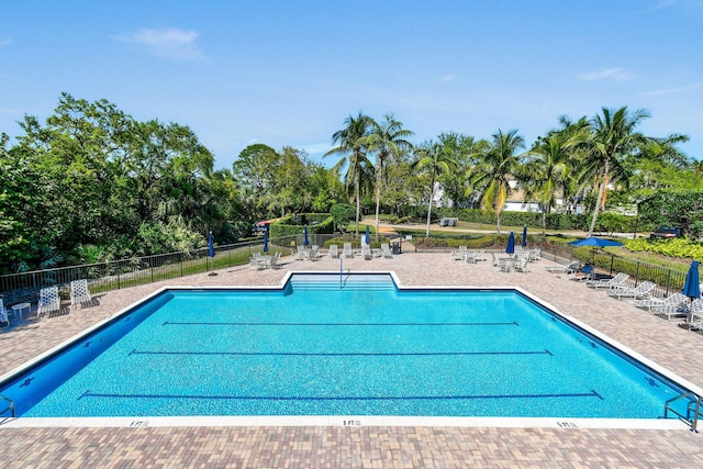 community pool featuring a patio area and fence