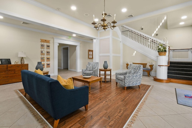 living area featuring visible vents, stairs, and ornamental molding