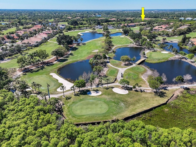 aerial view with golf course view and a water view