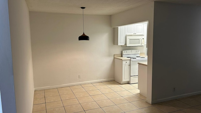 kitchen featuring decorative light fixtures, light tile patterned floors, light countertops, white cabinets, and white appliances