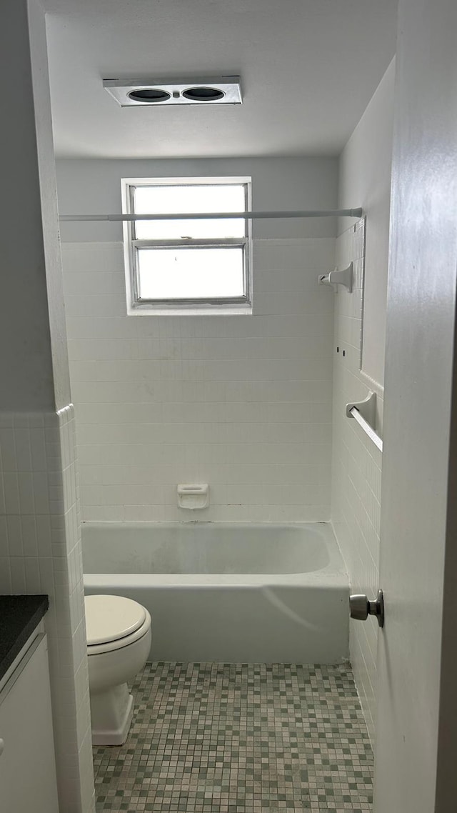 bathroom with vanity, tile patterned flooring, bathtub / shower combination, and toilet