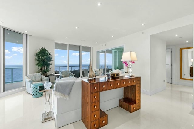 living room featuring expansive windows, a water view, baseboards, and recessed lighting