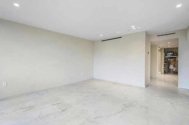 spare room with recessed lighting