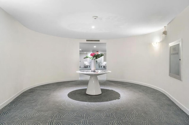 hallway featuring visible vents and baseboards