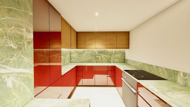 kitchen featuring range with electric stovetop, red cabinets, black electric stovetop, light countertops, and decorative backsplash