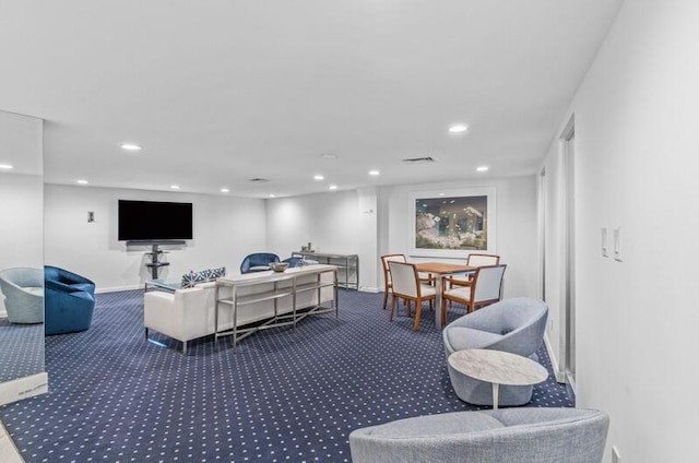 carpeted living room featuring baseboards, visible vents, and recessed lighting