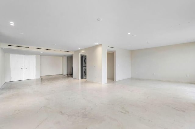 spare room with recessed lighting and stacked washer / drying machine