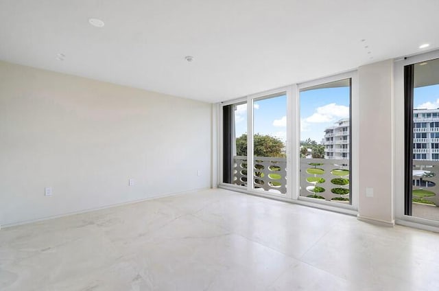 empty room featuring floor to ceiling windows and concrete floors