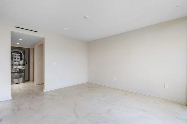 spare room featuring visible vents and baseboards