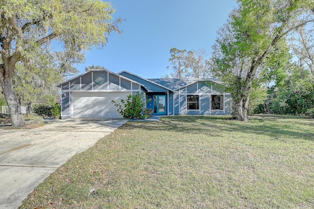 view of front facade with a garage, driveway, and a front yard