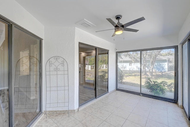 unfurnished sunroom featuring a ceiling fan and visible vents