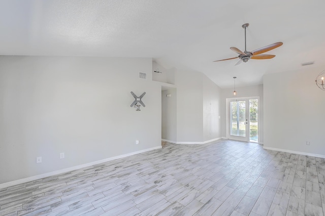 spare room featuring visible vents, baseboards, vaulted ceiling, french doors, and a ceiling fan