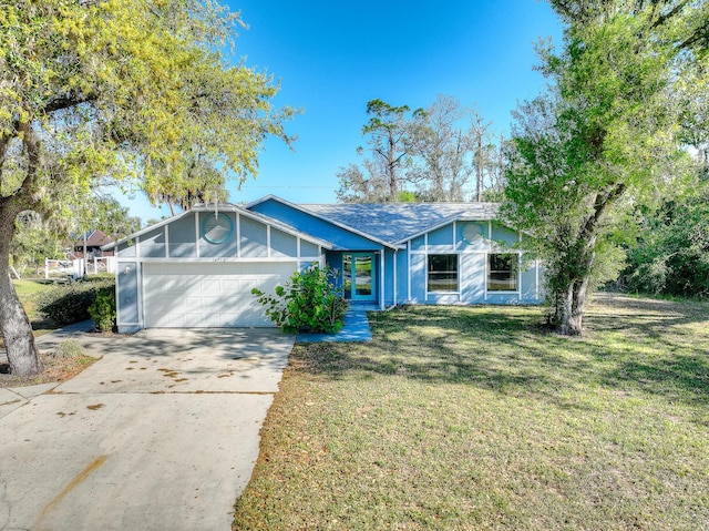 view of front of house with a garage, driveway, and a front yard