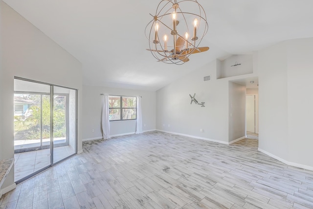 spare room featuring a notable chandelier, visible vents, high vaulted ceiling, and baseboards