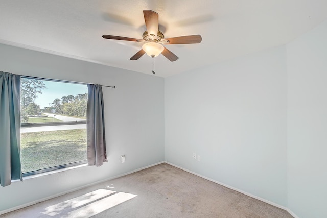 empty room with baseboards, carpet, and a ceiling fan