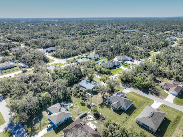 birds eye view of property featuring a residential view and a view of trees