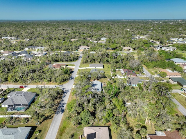 drone / aerial view with a view of trees and a residential view