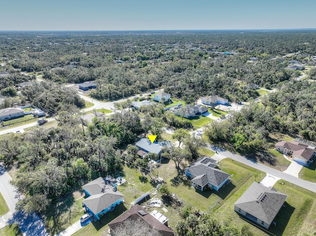 aerial view featuring a forest view and a residential view