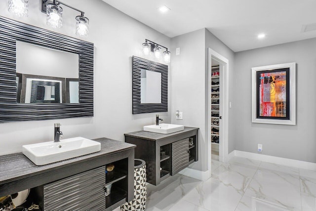 full bath with recessed lighting, marble finish floor, a sink, and baseboards