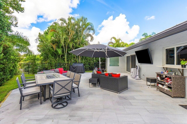 view of patio with a grill, fence, outdoor lounge area, and outdoor dining space