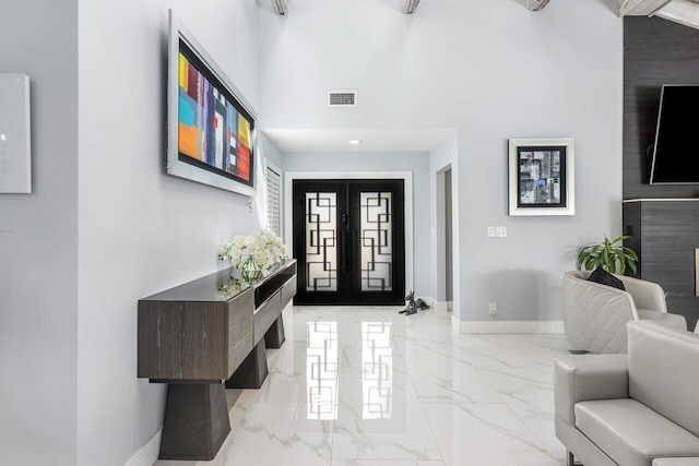 entryway with marble finish floor, french doors, visible vents, and baseboards