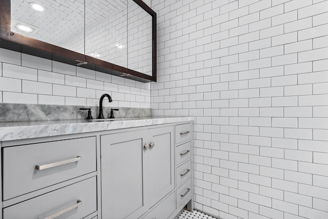 bathroom with decorative backsplash, tile walls, and vanity