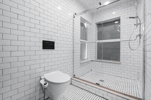 full bathroom featuring a stall shower, tile patterned flooring, and toilet