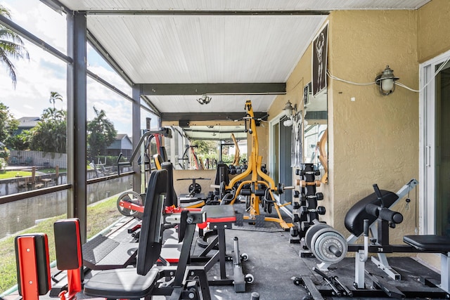 workout area featuring lofted ceiling and a textured wall