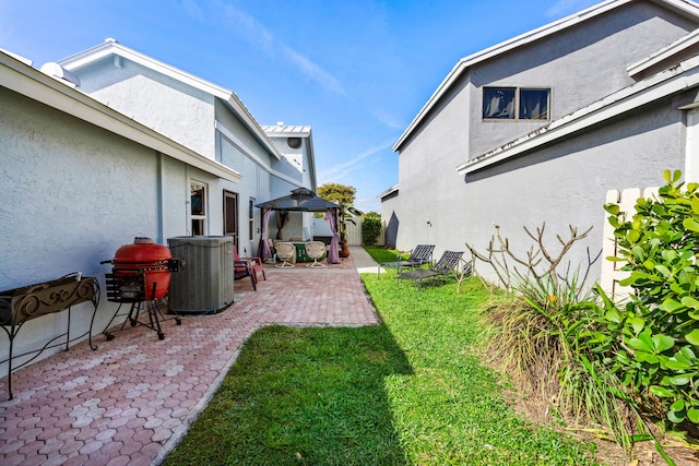 view of yard with a patio area, central AC unit, and a gazebo