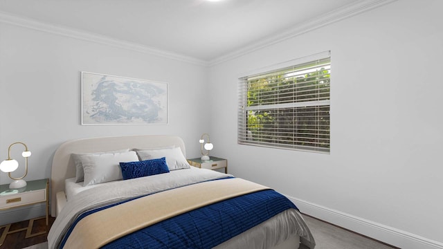 bedroom with baseboards and crown molding