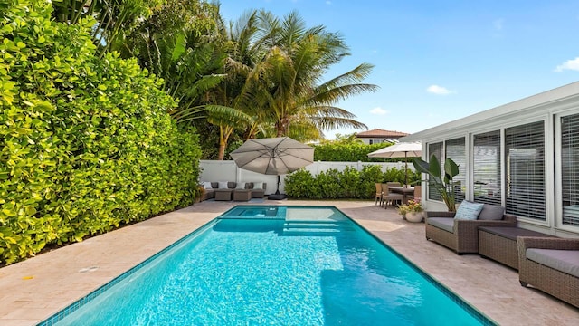 view of pool with a patio area, fence, and a fenced in pool