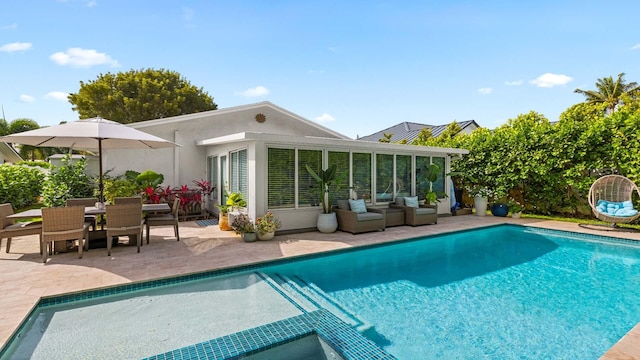 pool featuring outdoor dining area and a patio area