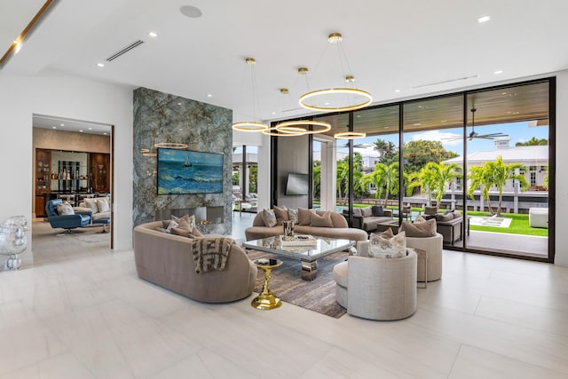 living room featuring visible vents, floor to ceiling windows, a chandelier, and recessed lighting