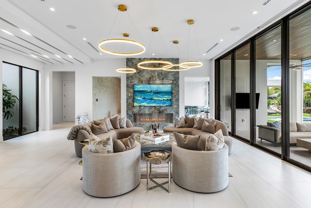 living area with recessed lighting, a fireplace, and expansive windows