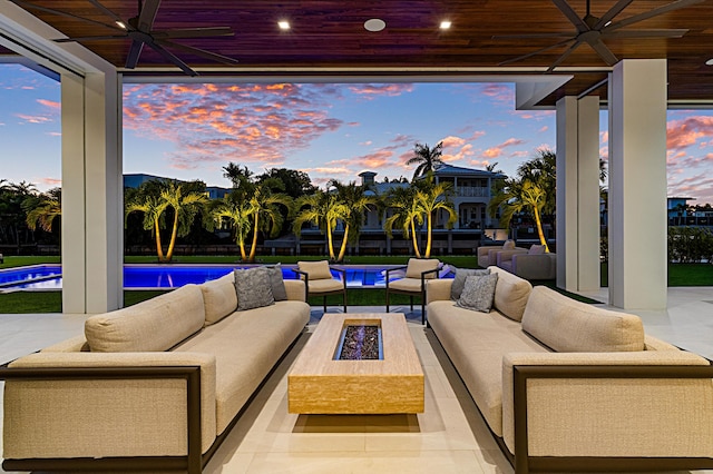 view of patio / terrace with ceiling fan, an outdoor living space with a fire pit, and an outdoor pool