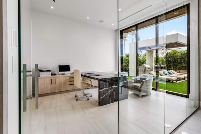 office area with built in desk and recessed lighting