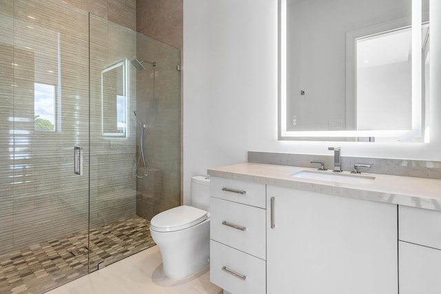 bathroom featuring a stall shower, vanity, and toilet