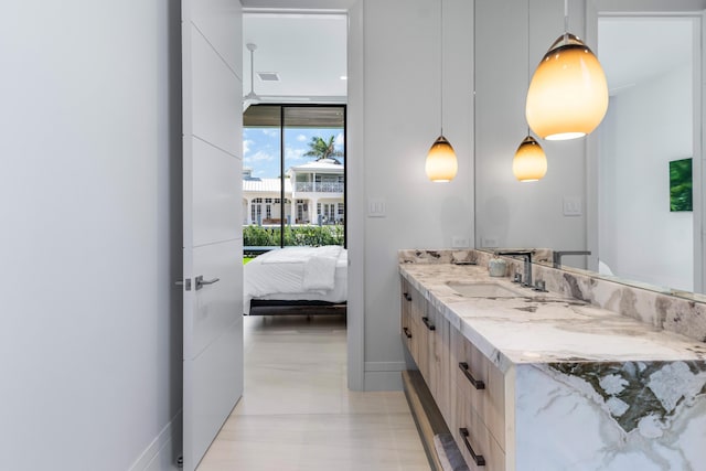 ensuite bathroom with visible vents, ensuite bath, vanity, and baseboards