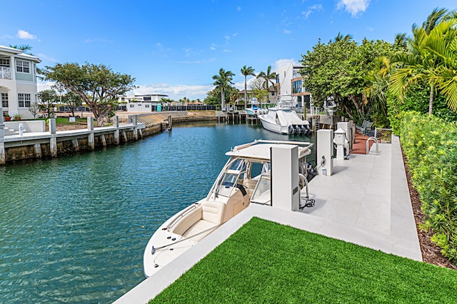 dock area featuring a lawn and a water view