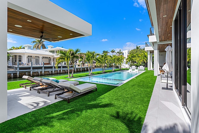 exterior space featuring ceiling fan, a patio area, and an outdoor pool