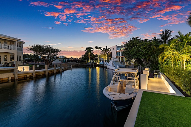 view of dock featuring a water view and a lawn