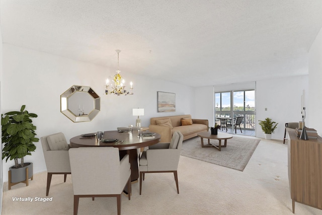 dining room with a textured ceiling, an inviting chandelier, and light colored carpet