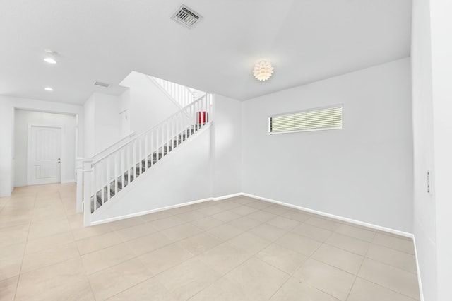 unfurnished room with stairway, baseboards, visible vents, light tile patterned flooring, and recessed lighting