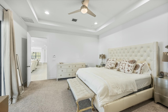 carpeted bedroom with visible vents, recessed lighting, a raised ceiling, and ceiling fan